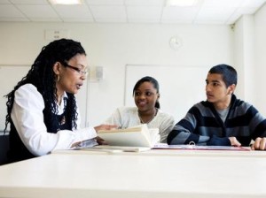 Student teacher help black classroom