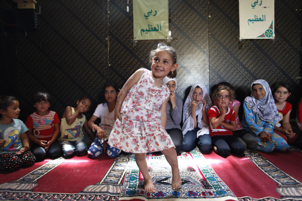 Syrian refugee children participate in a religion class in the Ketermaya refugee camp, outside Beirut, Lebanon on June 1, 2014. Over 50 Syrian families have found safety and temporary shelter for last year and half in the refugee camp. (The families requested not to use their names because of security concerns) Photo © Dominic Chavez/World Bank