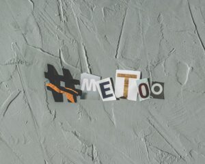 A collage of letters and symbols on a gray background that spells out #METOO